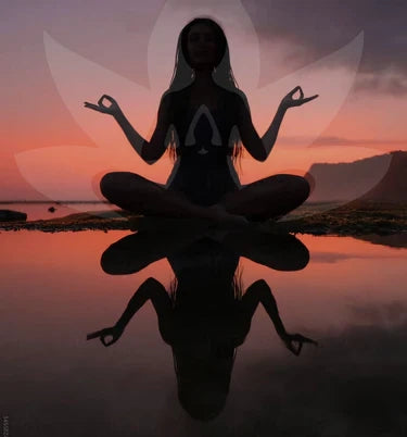 Silhouette of a person meditating with a sunset and reflection in the background